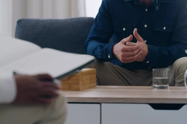 Patient and psychologist sit at table