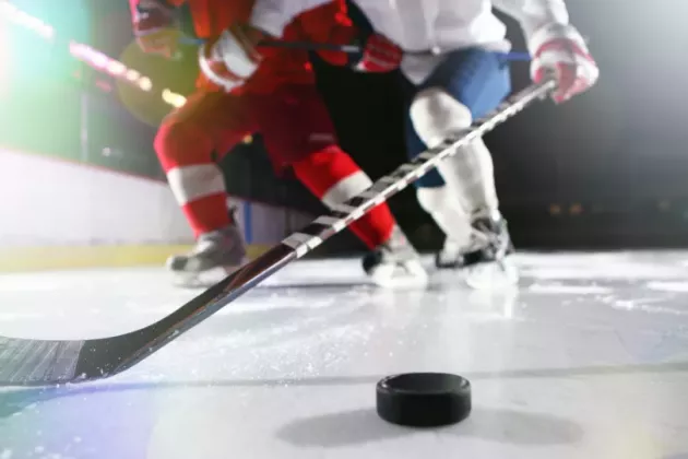 Hockey player with puck on ice