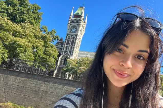 A selfie of a student abroad in front of a church. Photo.