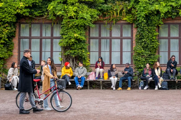 Students sitting, walking and talking close to the Odeum building in Lund. Photo: Kennet Ruona.