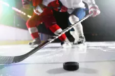 Hockey player with puck on ice