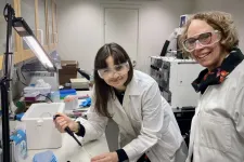 Nikol Labecka and Emma Sparr in a lab wearing lab coats