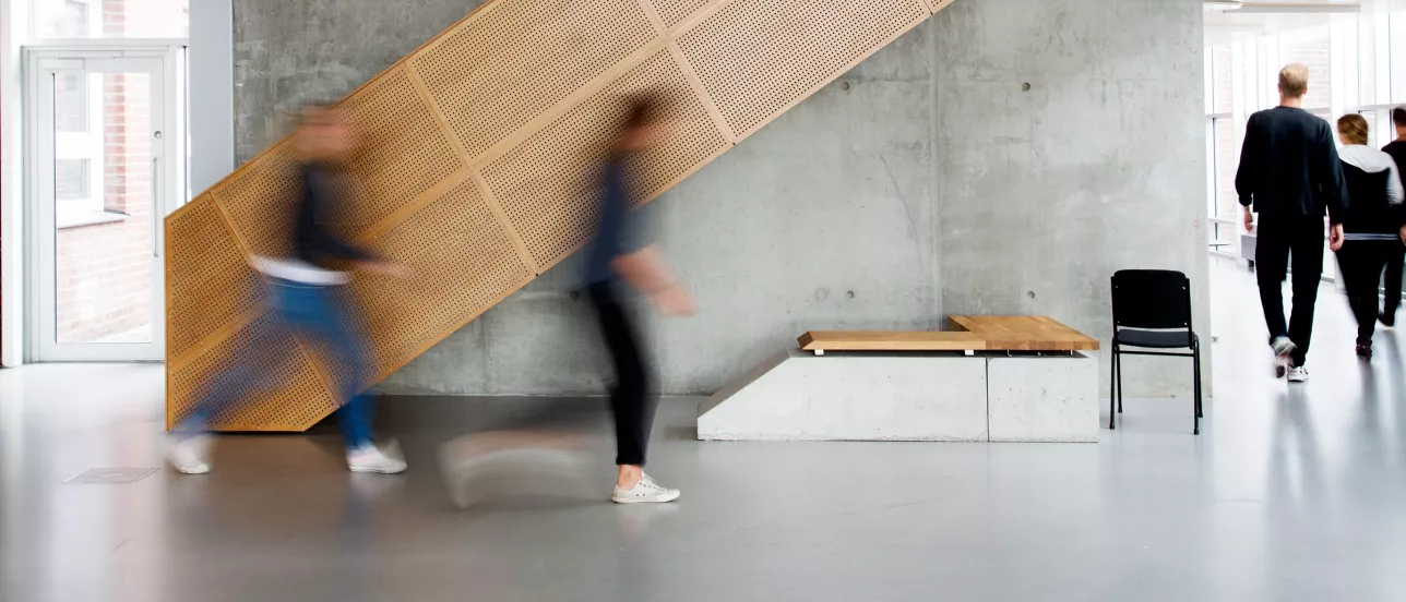 Blurry students walking in front of a staircase