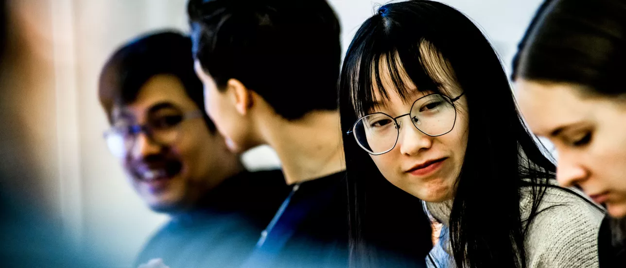 Four students doing group work together at the Graduate School