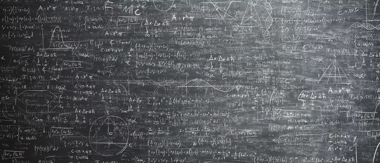 A lot of formulas and graphs on a blackboard