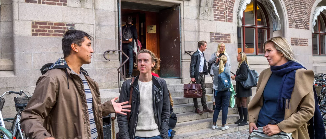 Students and professors talking outside the Faculty of Law