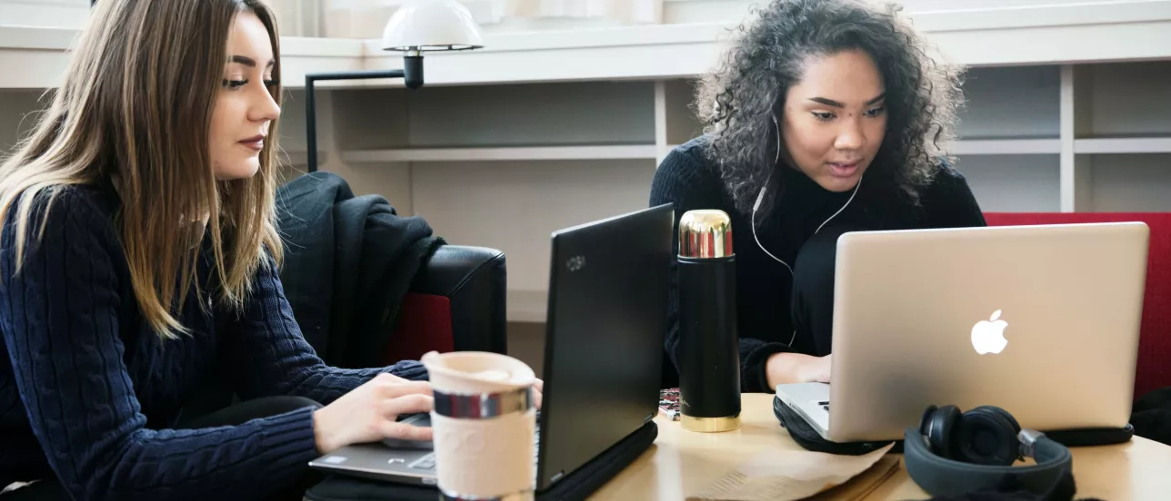 Two students studying at the library at the Faculty of Social Sciences