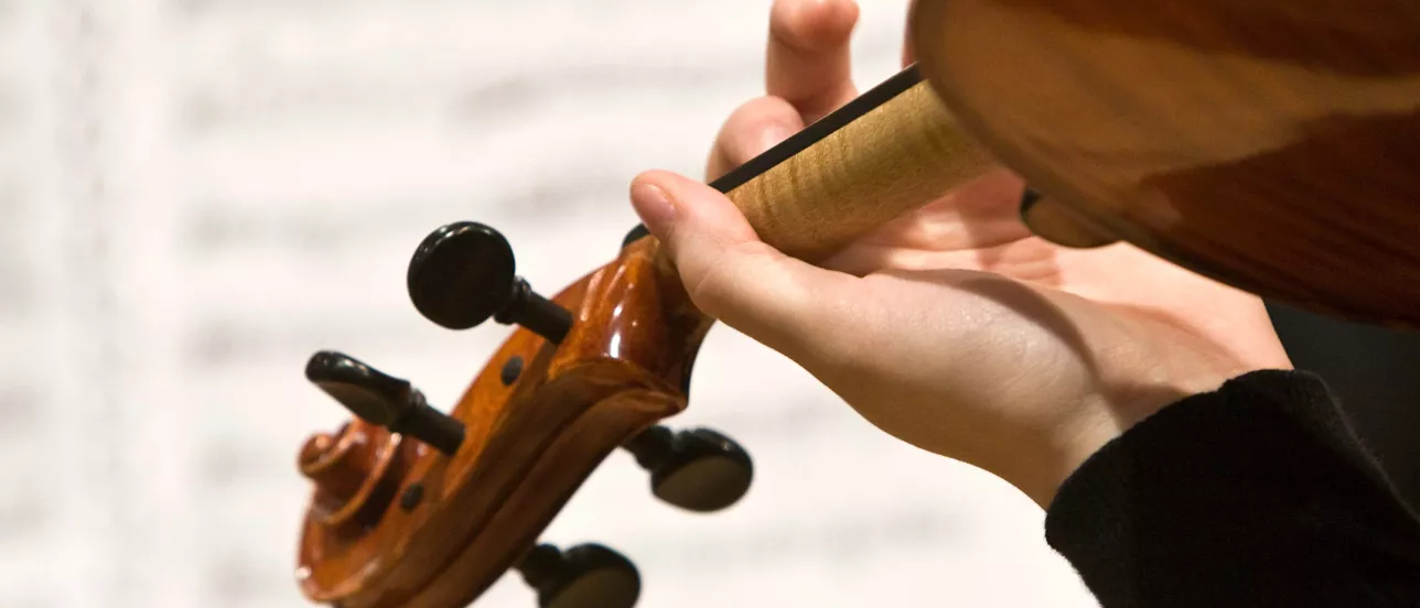 Someone playing an instrument with a note book in the background