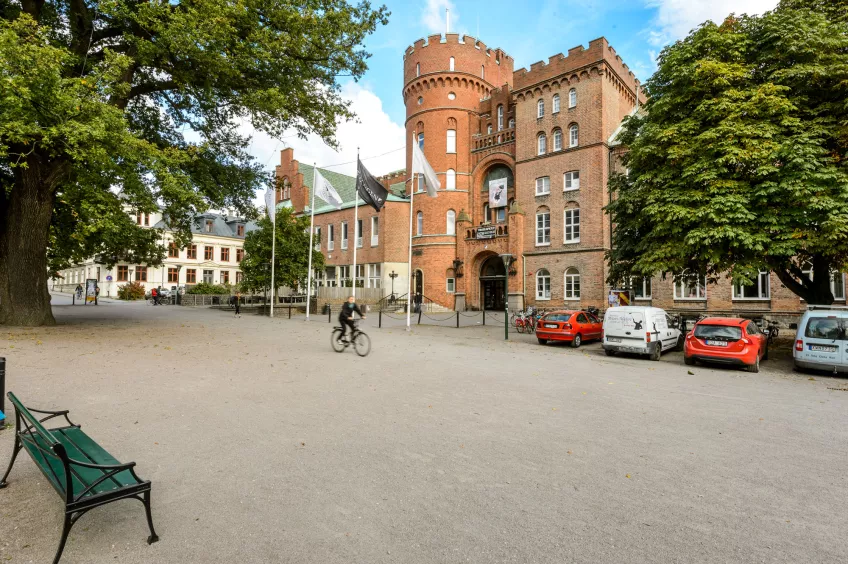 The AF Building in summertime with a cyclist passing by