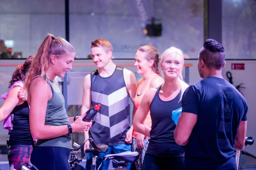 Students talking after a spinning class at Gerdahallen