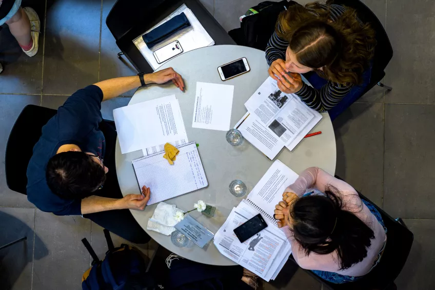 Three students studying together at a table