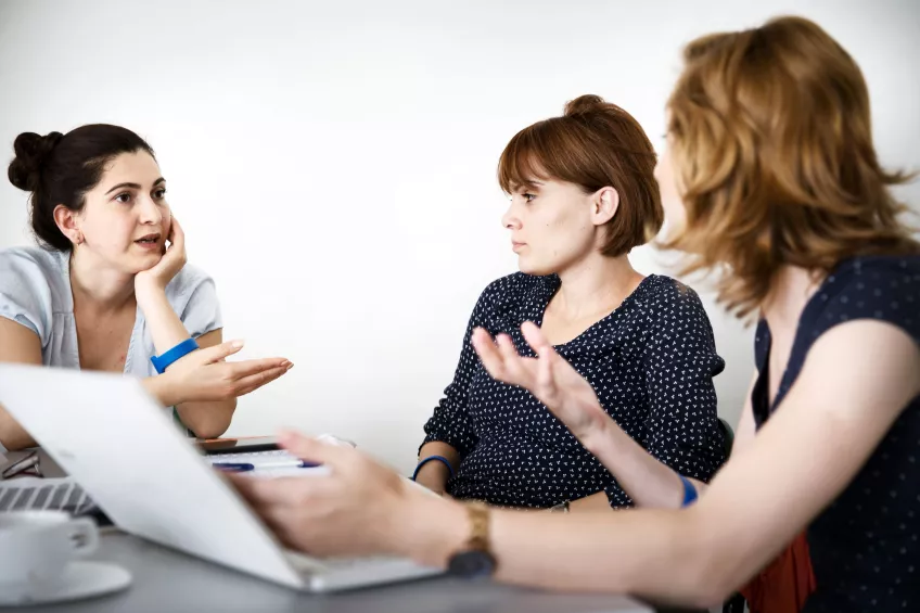 Three women discussing something