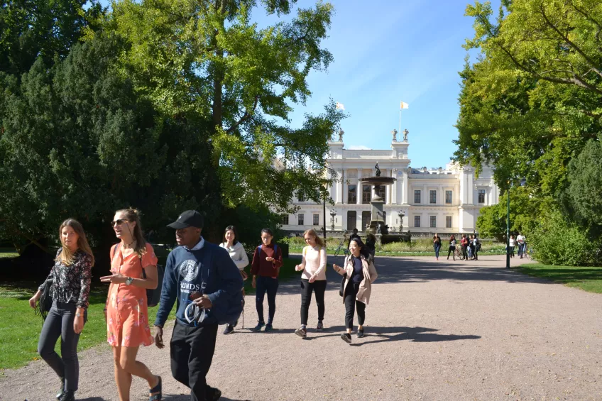 Students part of a campus tour walking close to the Main University Building