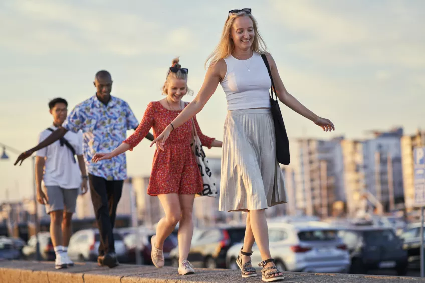 Students walking in a row in the sun.Photo.